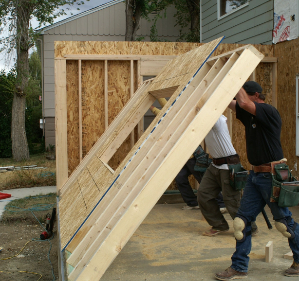 men working to add a part of a house